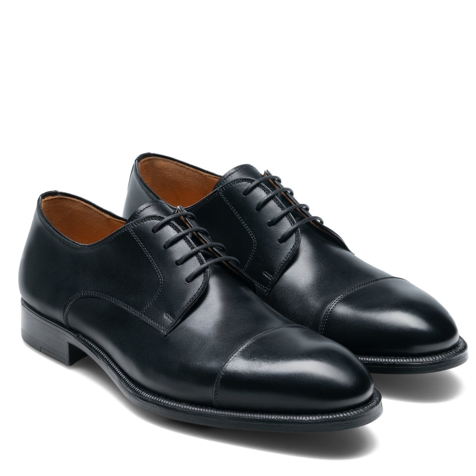 Pair of black dress shoes on a white background