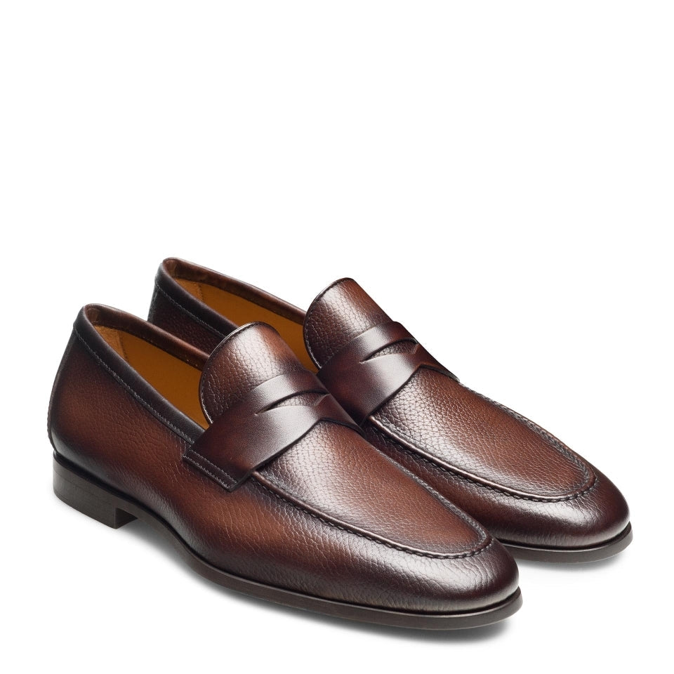 Pair of brown loafers on a white background
